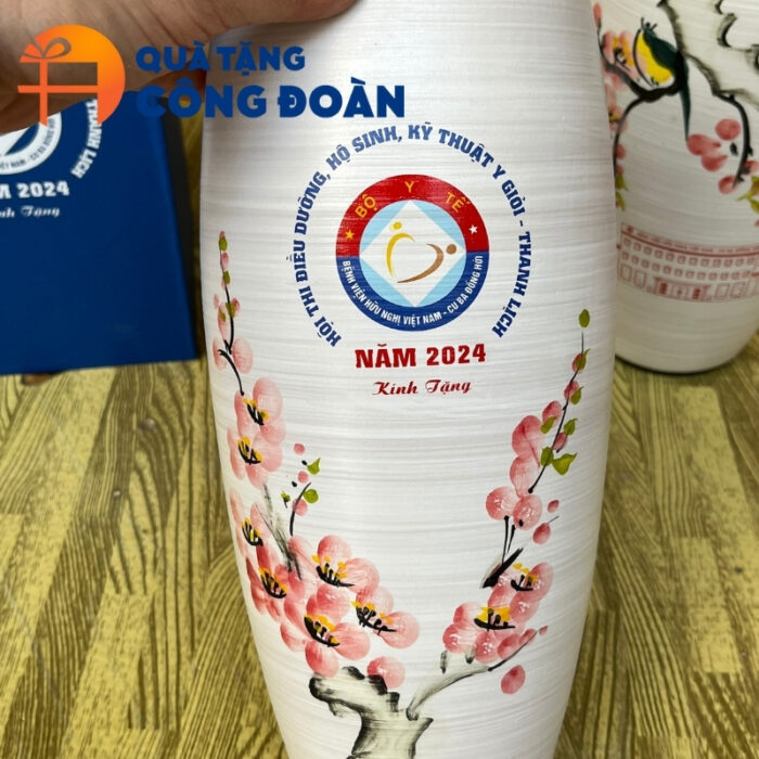 Cận cảnh họa tiết hoa đào vẽ tay và logo in decal rõ nét trên bề mặt men xước