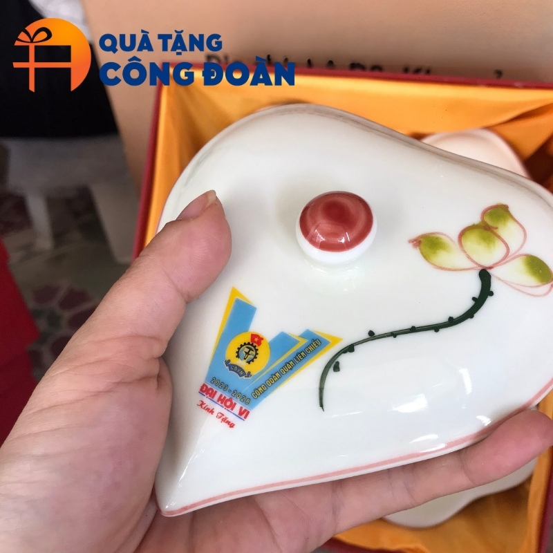 Cận cảnh họa tiết hoa sen vẽ tay và logo đơn vị được in decal sắc nét trên sản phẩm